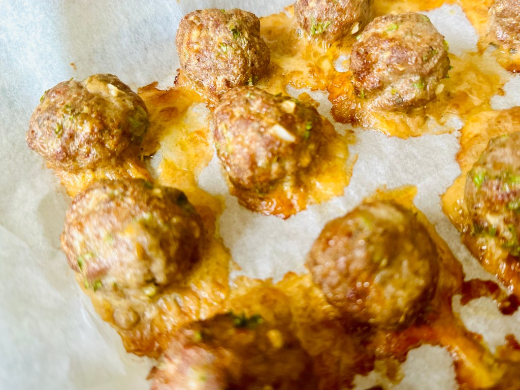 Baked meatballs on a baking sheet