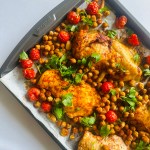 Sheet pan full of cherry tomatoes, chicken, and chickpeas