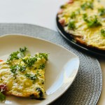 A plate of egg frittata on a placemat