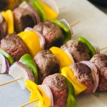 Wooden skewers with meatballs and grilled veggies threaded