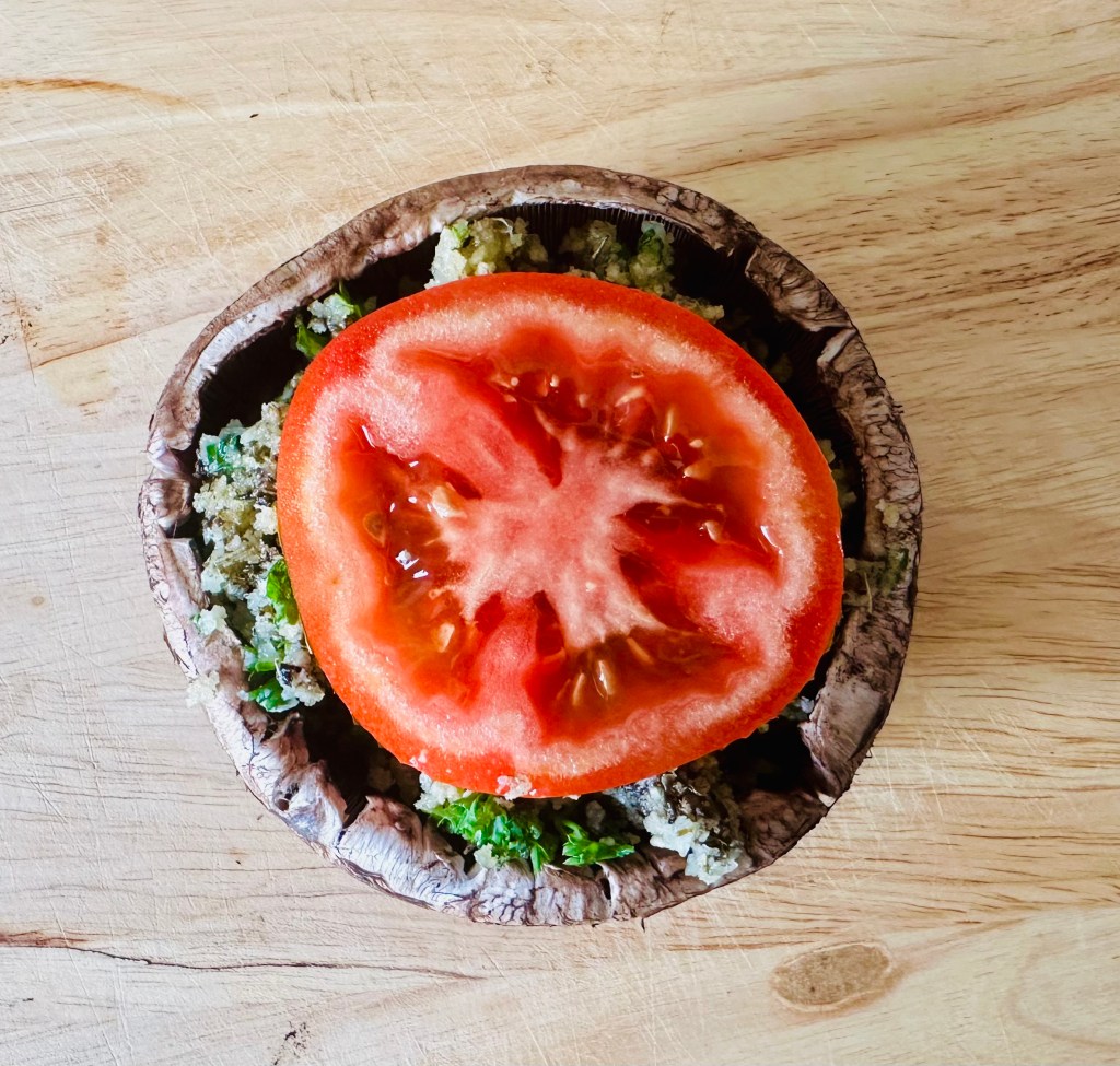Portobello mushroom top with sliced tomato