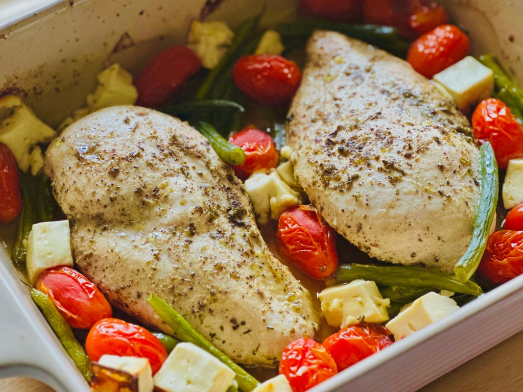 Baked chicken with roasted tomatoes, green beans, and feta