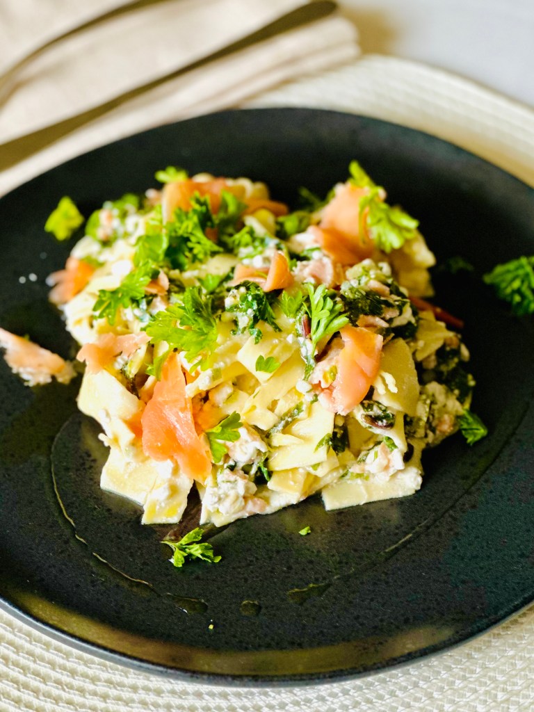 Smoked salmon layered with lasagna, cottage cheese, Parmesan cheese, lemon, and greens