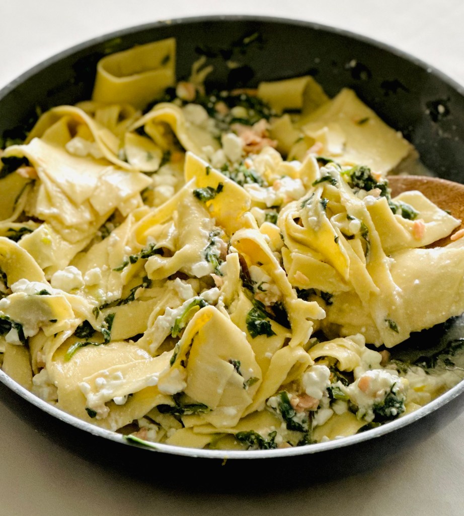 Smoked salmon layered with lasagna, cottage cheese, Parmesan cheese, lemon, and greens