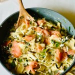 Smoked salmon layered in a pan with lasagna, cottage cheese, Parmesan cheese, lemon, and greens