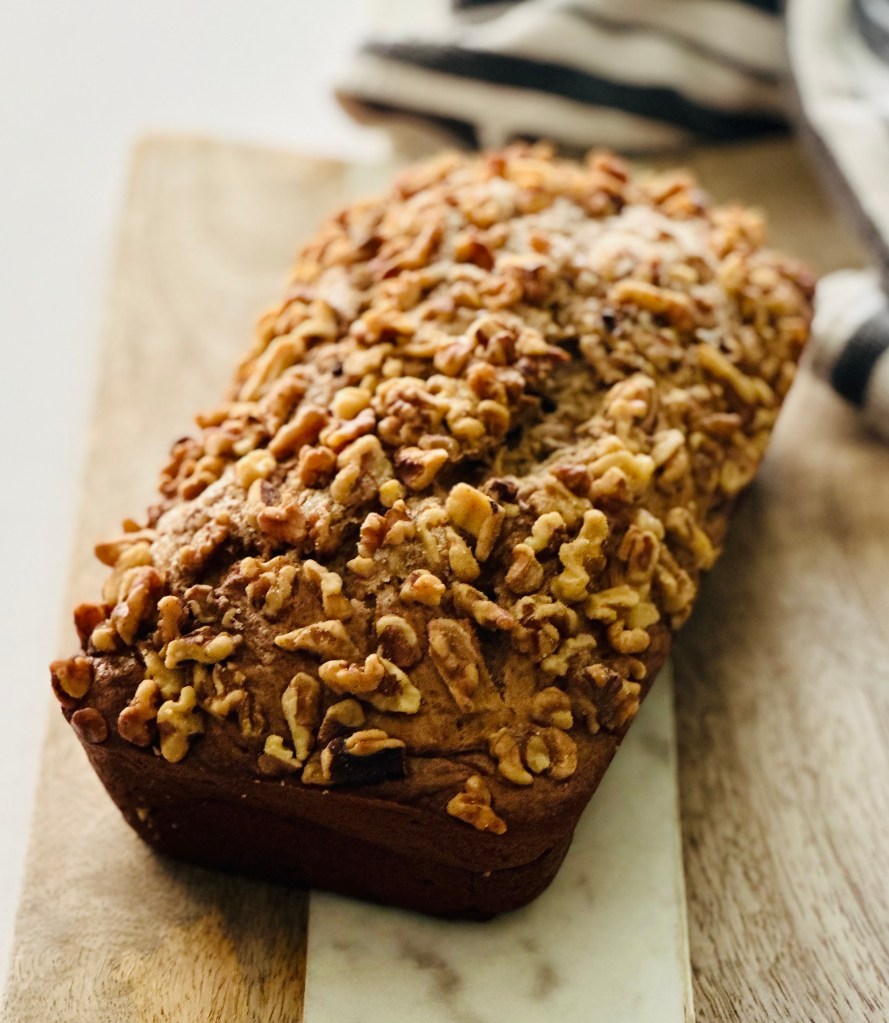 A banana bread loaf sitting on top of a cutting board