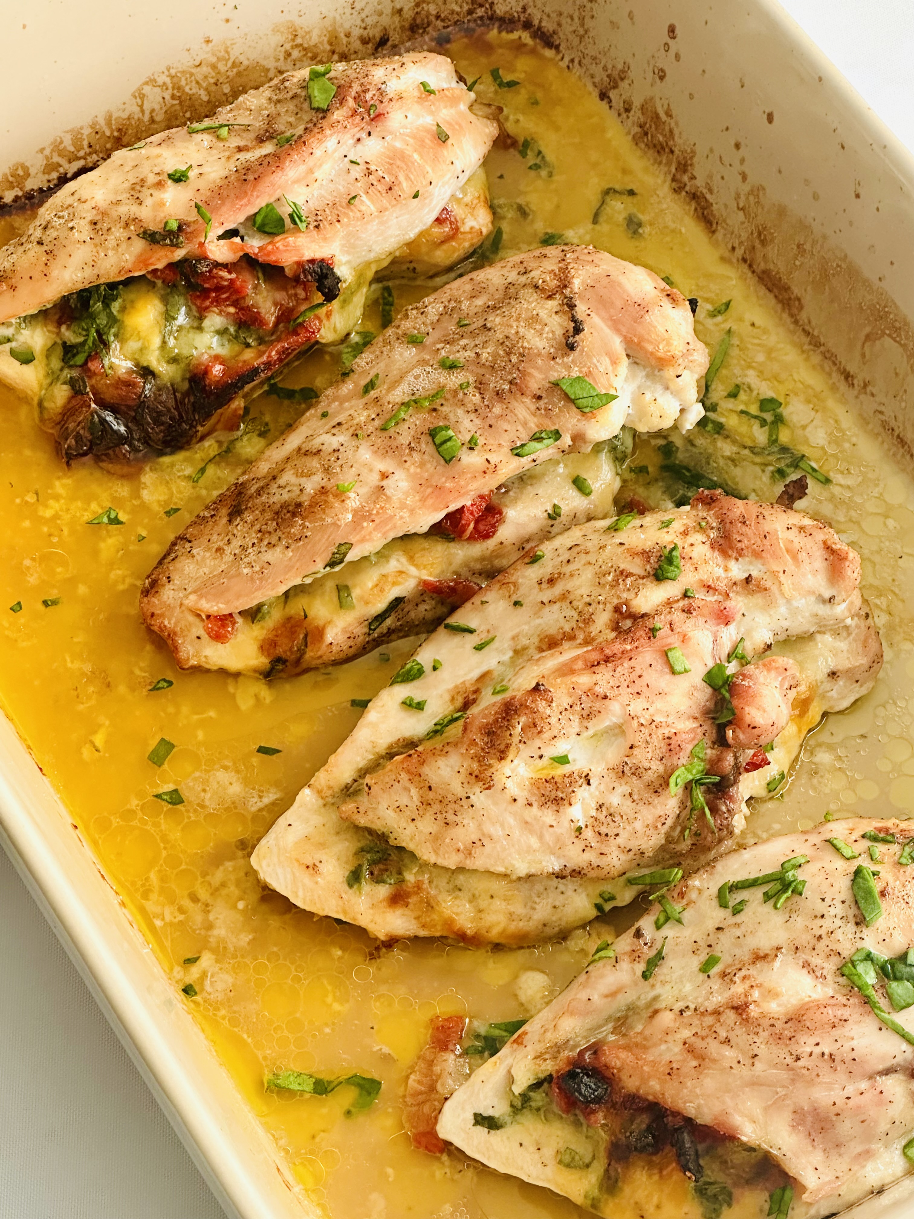 Baked chicken breasts stuffed with spinach, cheese, and sun-dried tomatoes