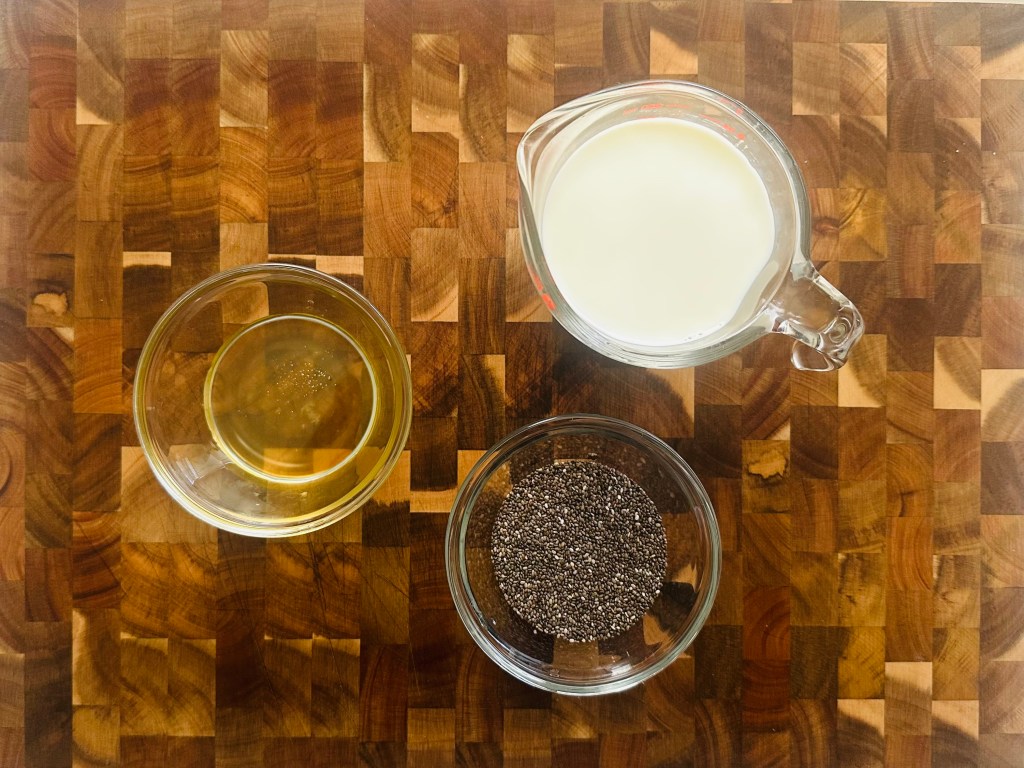 A photo of 1 cup milk, honey, and chia seeds for chia seed pudding