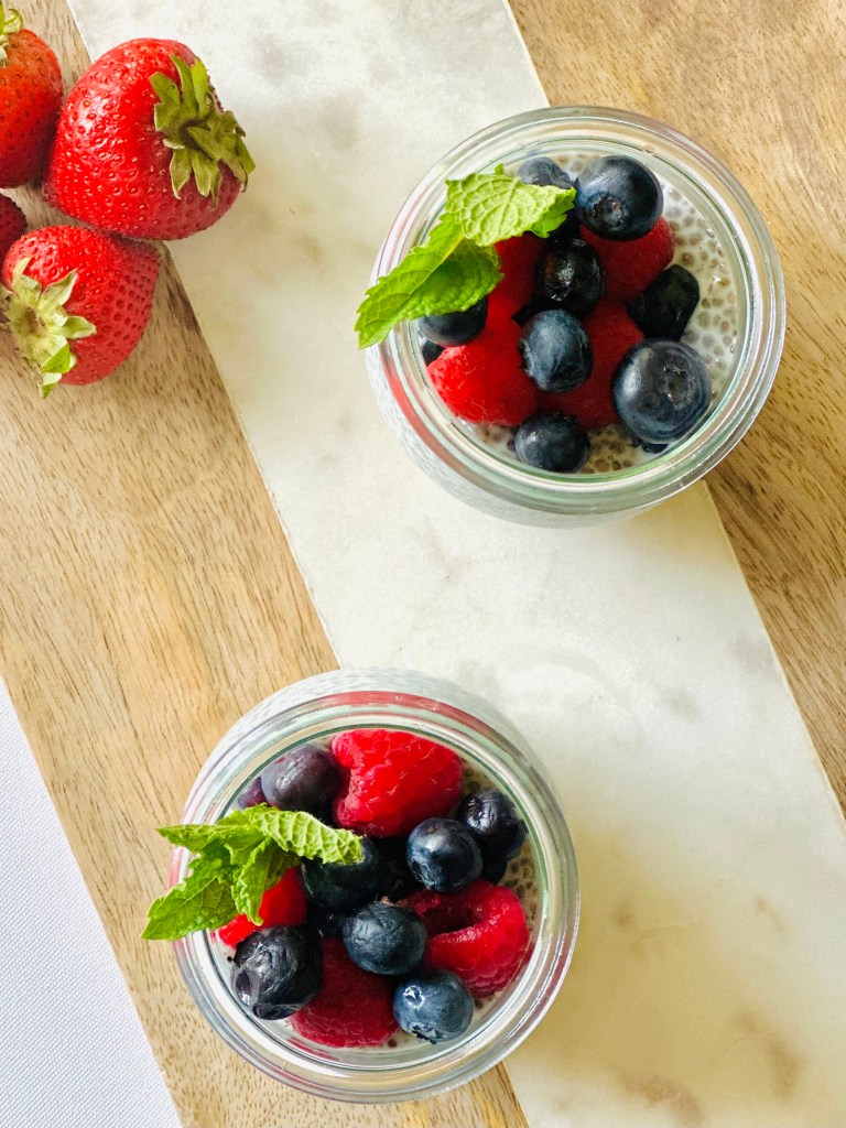 2 jars full of chia seed pudding and fresh berries