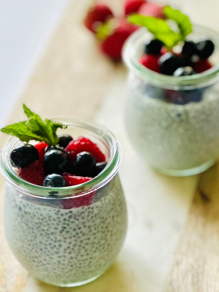 2 jars full of chia seed pudding and fresh berries
