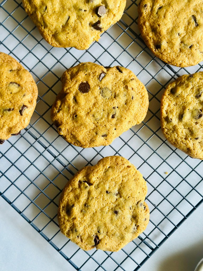 Baked chocolate chip cookies on a wire rack
