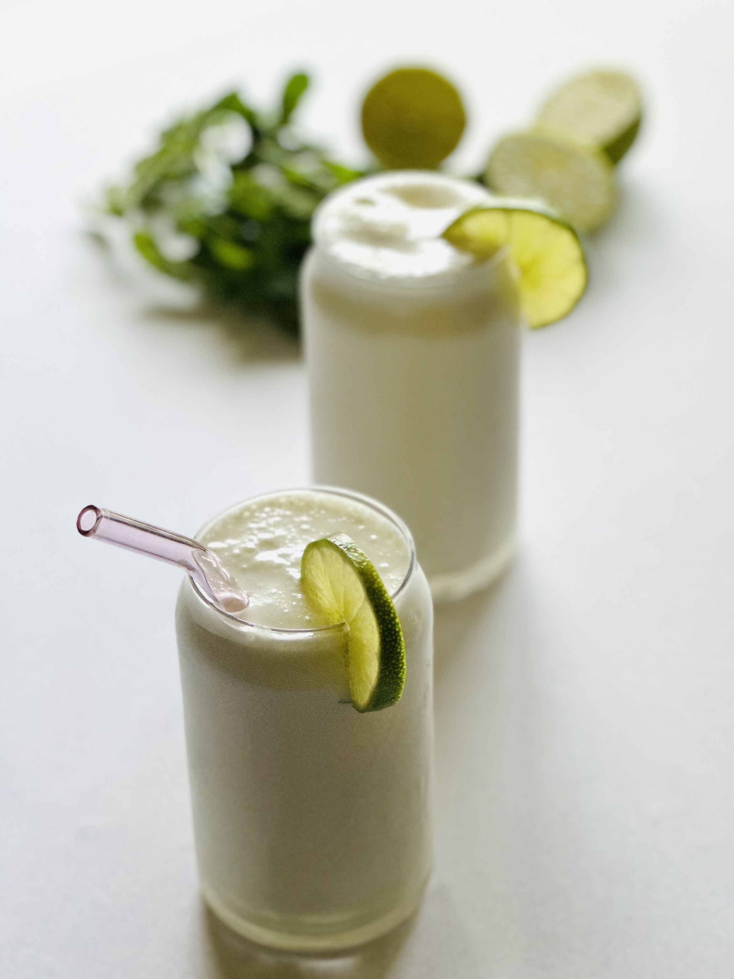 Tall glasses filled with Brazilian lemonade and served with lime wheels