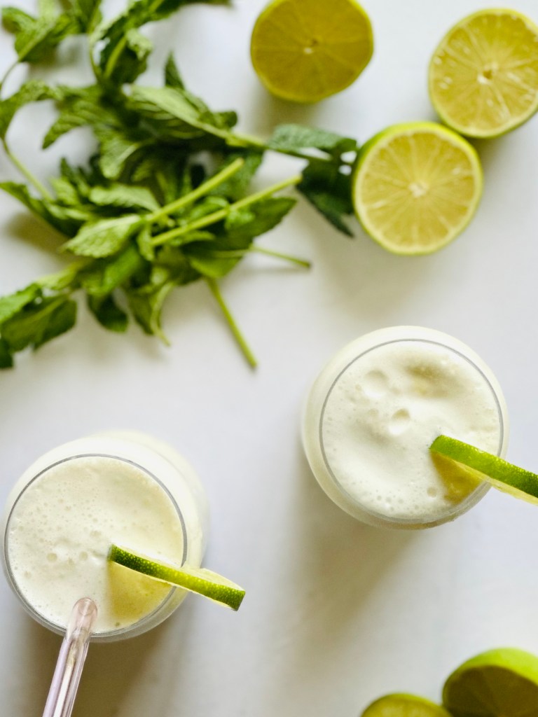 Tall glasses filled with Brazilian lemonade and served with lime wheels