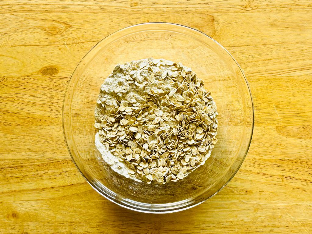 Bowl of dry ingredients used to make oatmeal raisin cookies