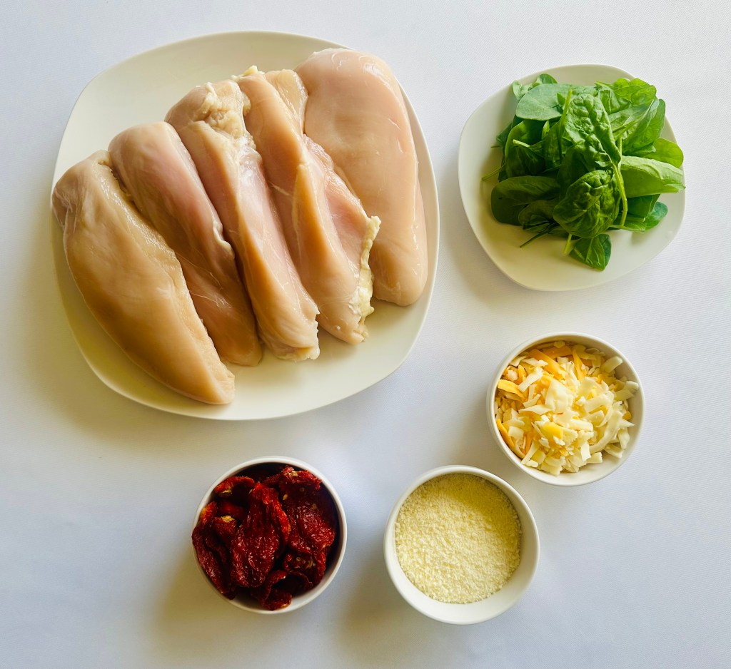 Photo of ingredients used to make stuffed chicken with spinach, cheese, and sun-dried tomatoes