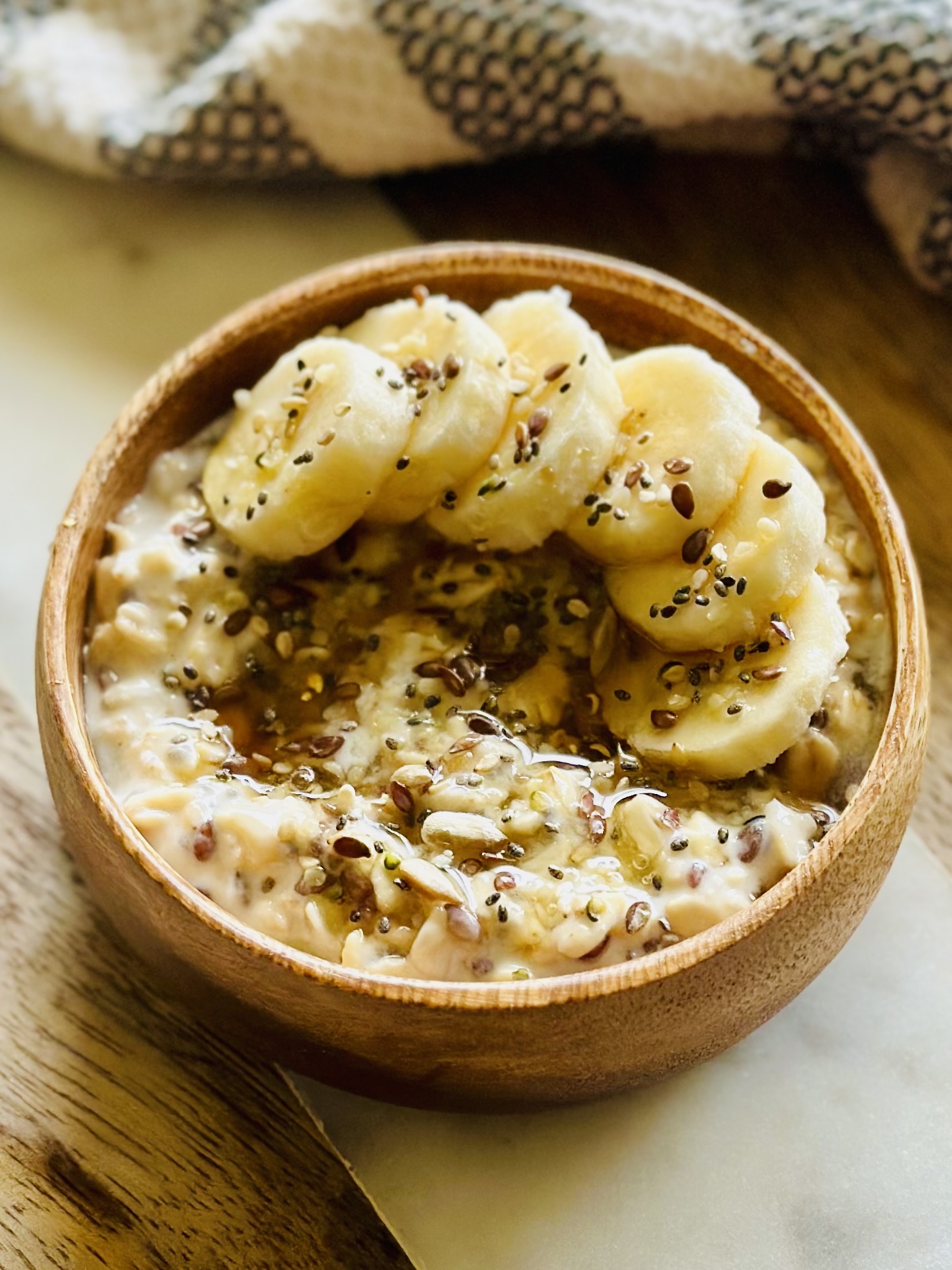 Overnight oats with honey and bananas in a wooden bowl