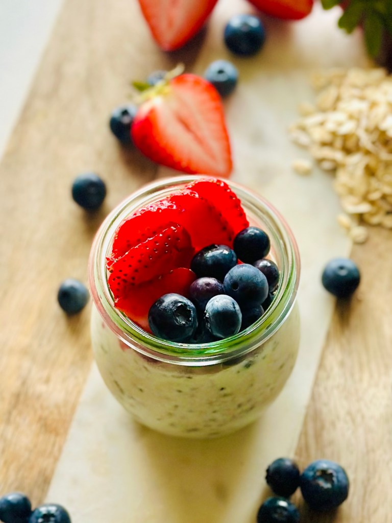 Jar filled with overnight oats and assorted berries