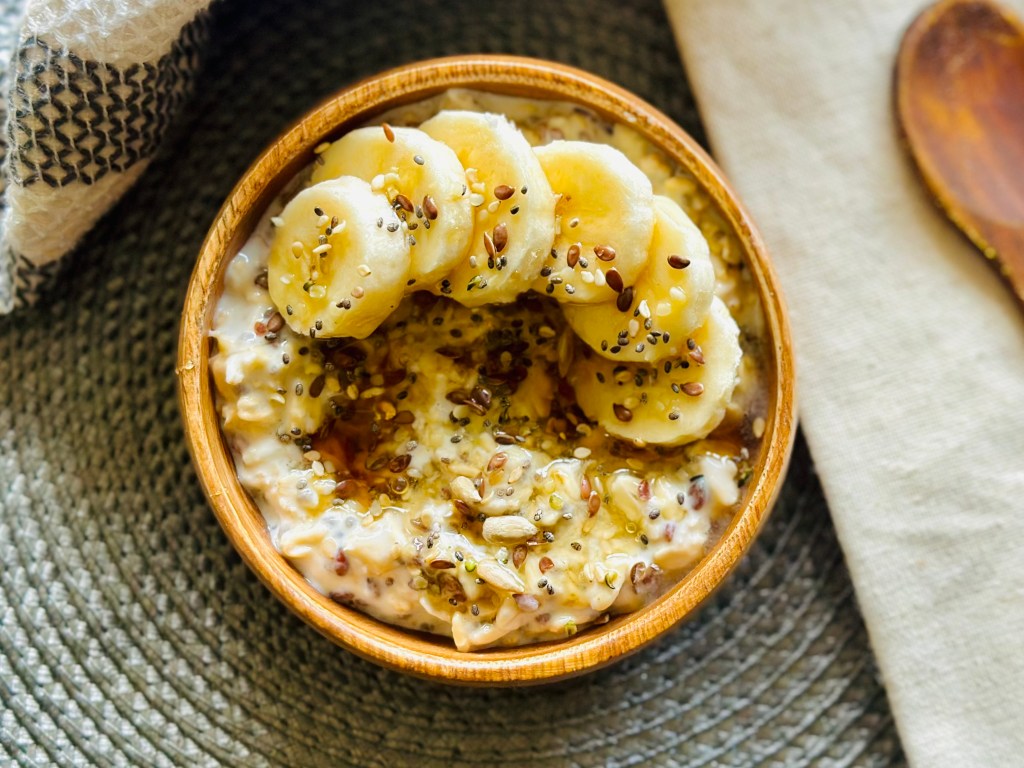 Overnight oats with honey and bananas in a wooden bowl