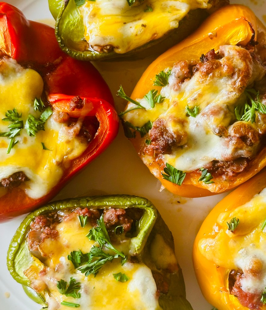 Stuffed bell peppers filled with ground beef, veggies, and melted cheese
