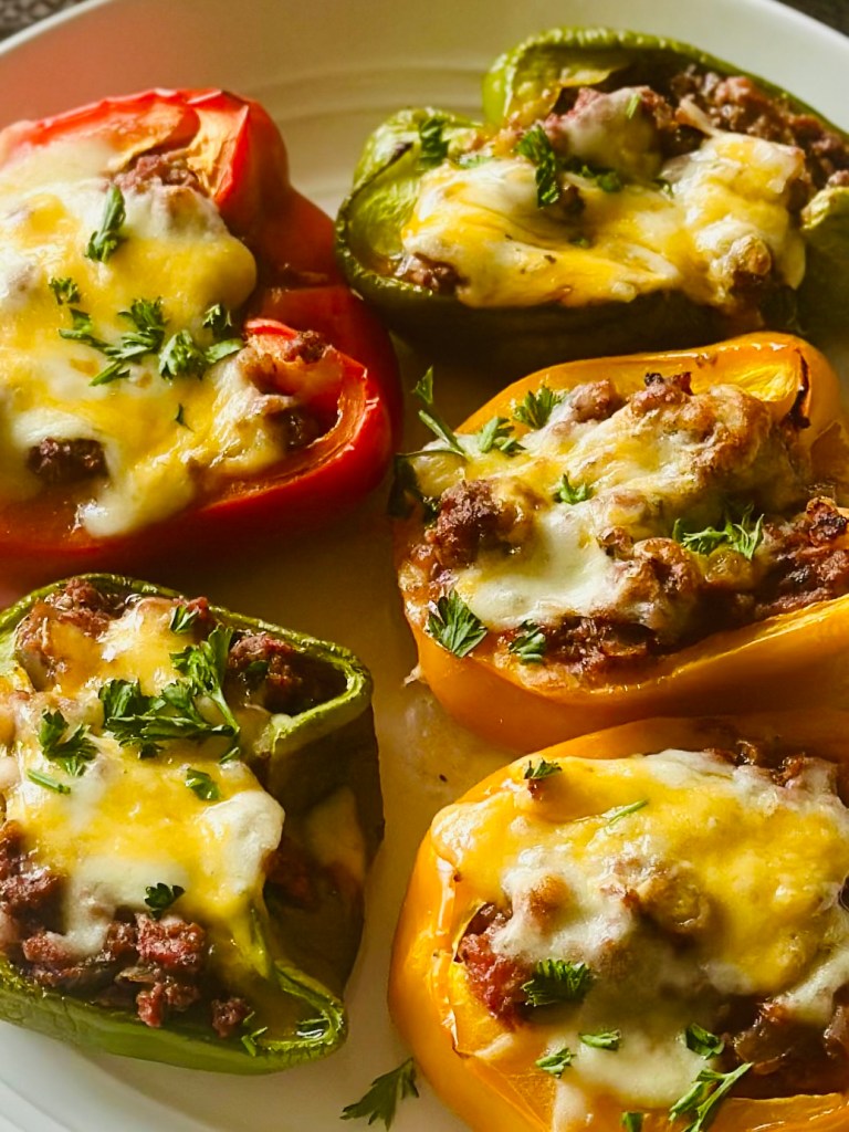 Stuffed bell peppers filled with ground beef, veggies, and melted cheese