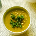 A bowl of homemade vegetarian split pea soup with parsley as garnish