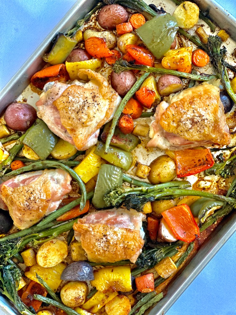 Juicy crisp chicken and roasted rainbow vegetables nestled in a sheet pan