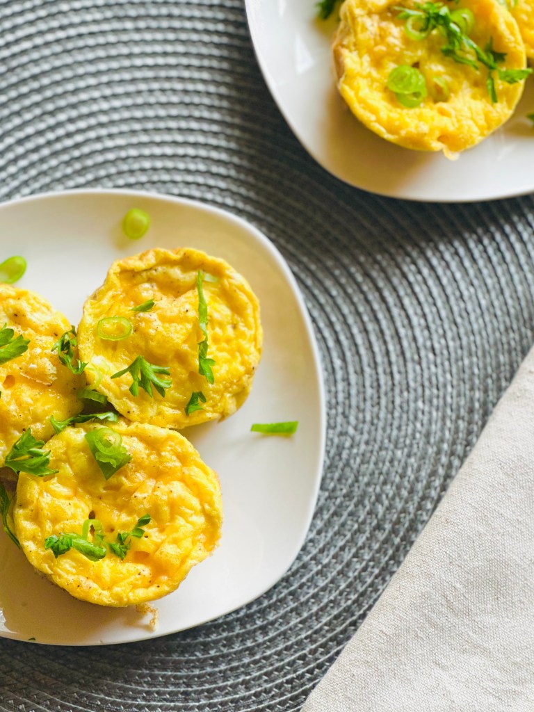 Serving plates full of homemade breakfast sausage egg muffins