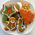A plate full of gingerbread cookies decorated with icing