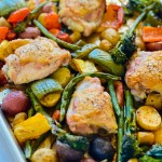 Juicy crisp chicken and roasted rainbow vegetables nestled in a sheet pan