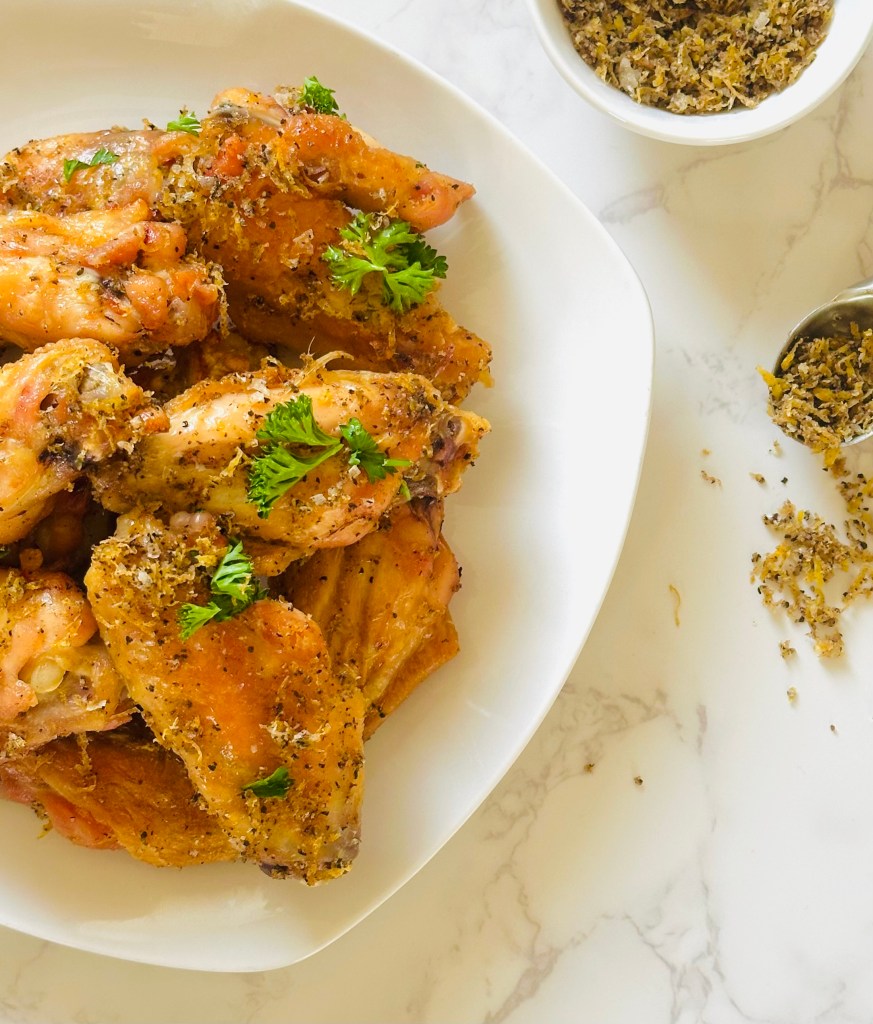 A plate full of crispy lemon pepper chicken wings
