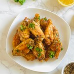 A plate full of crispy lemon pepper chicken wings