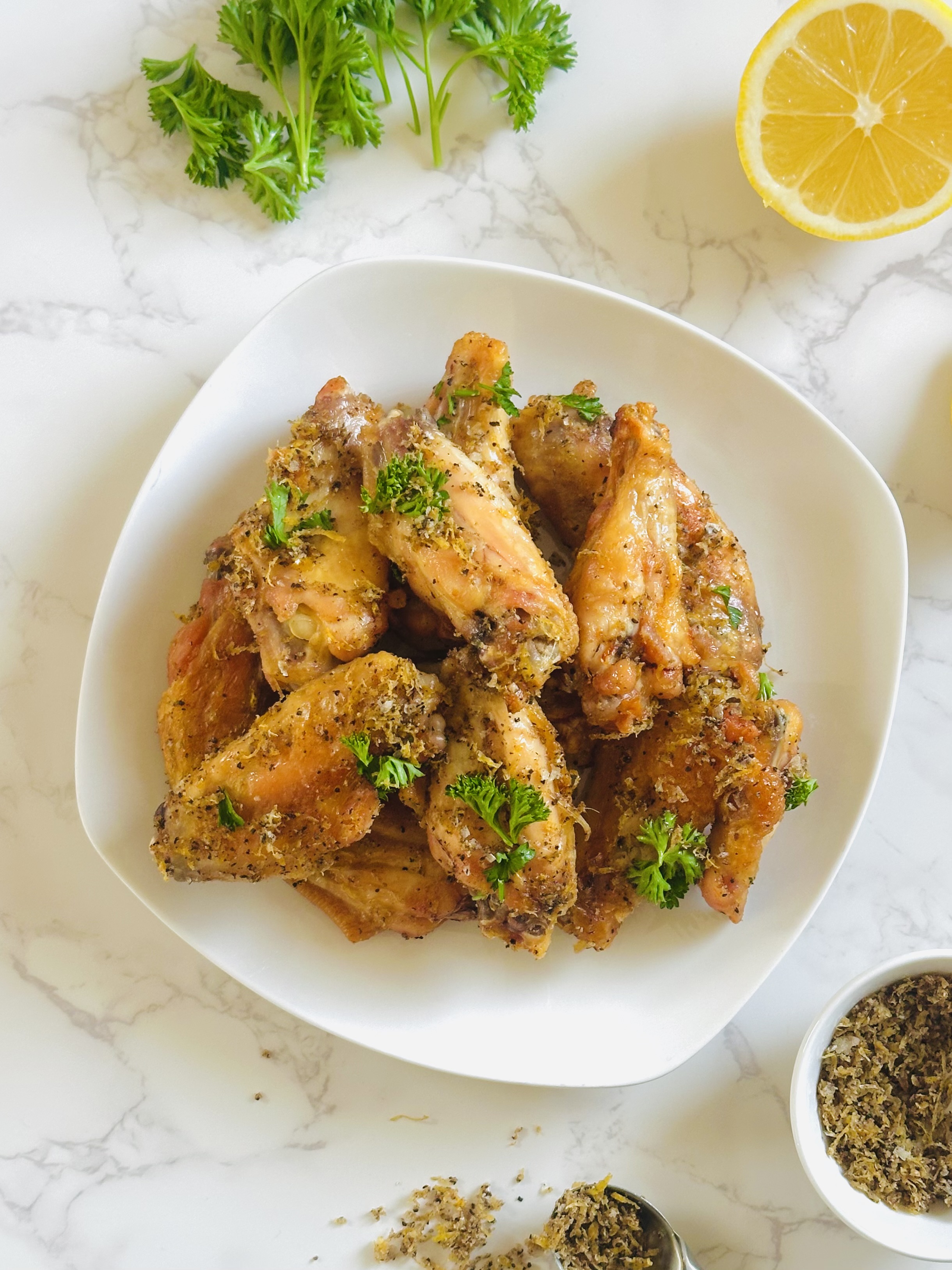 A plate full of crispy lemon pepper chicken wings