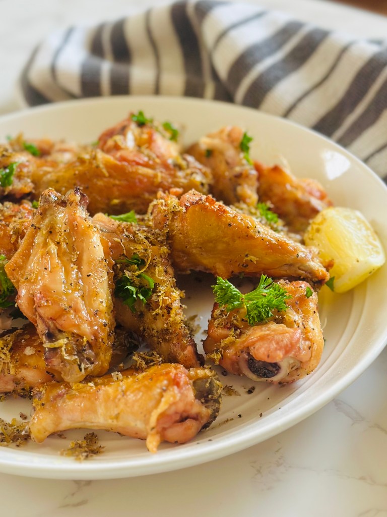 A plate full of crispy lemon pepper chicken wings