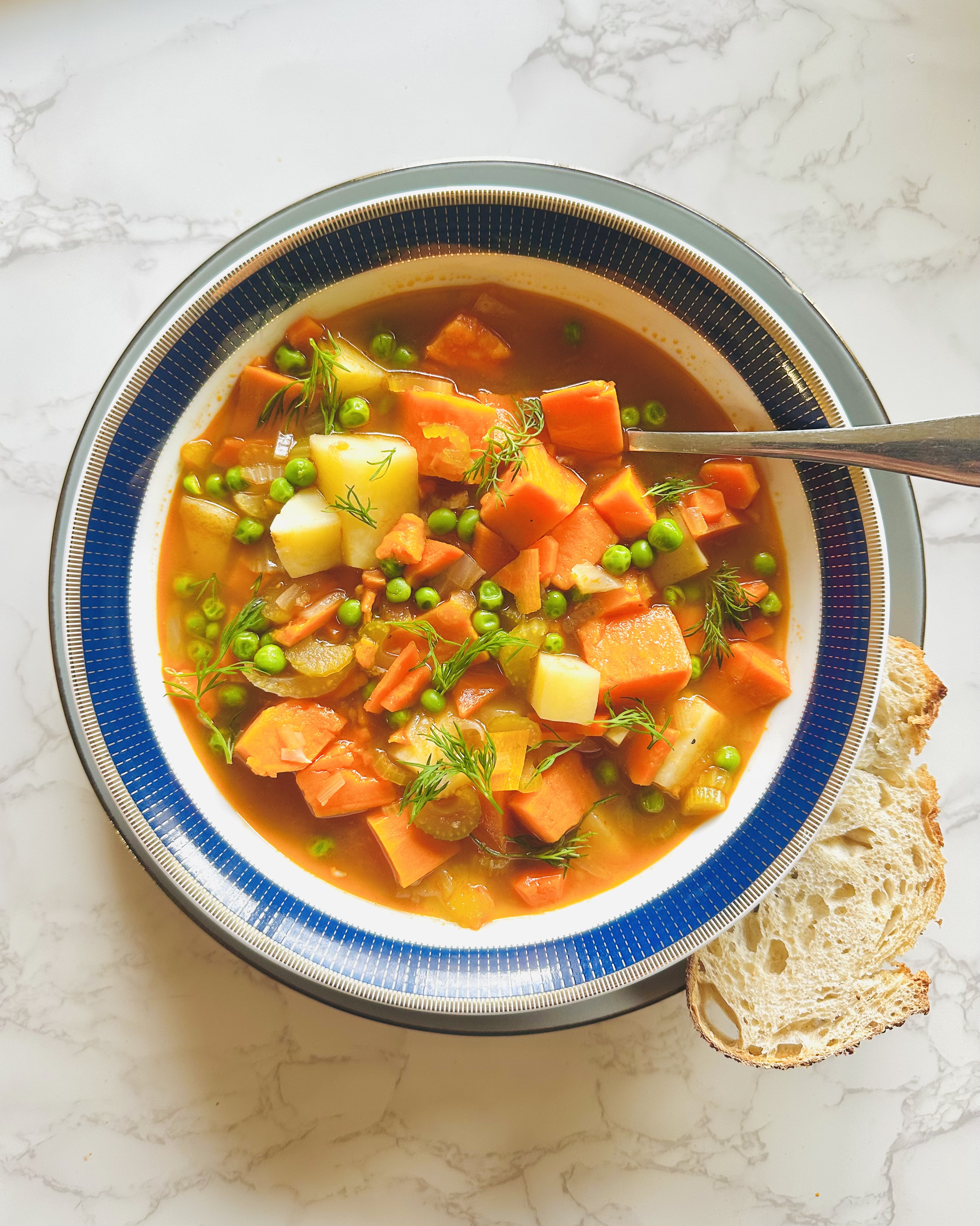 A hearty bowl of delicious winter vegetable soup with a side of sourdough bread