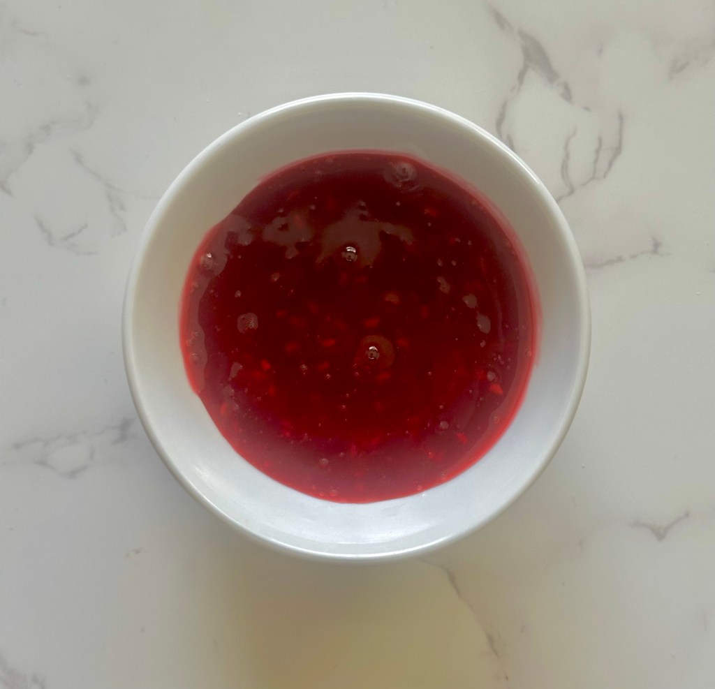 A bowl of homemade raspberry sauce