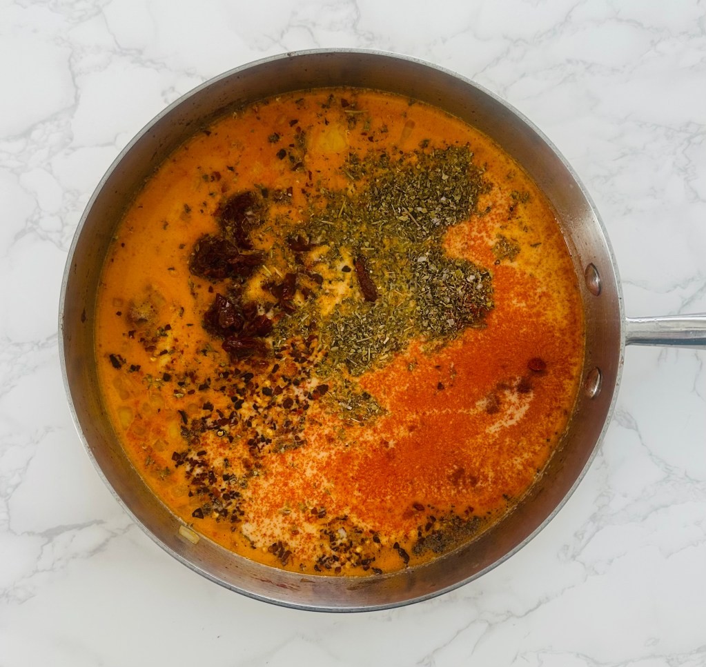 Cream-based sauce with chicken broth, sun-dried tomatoes, and seasonings