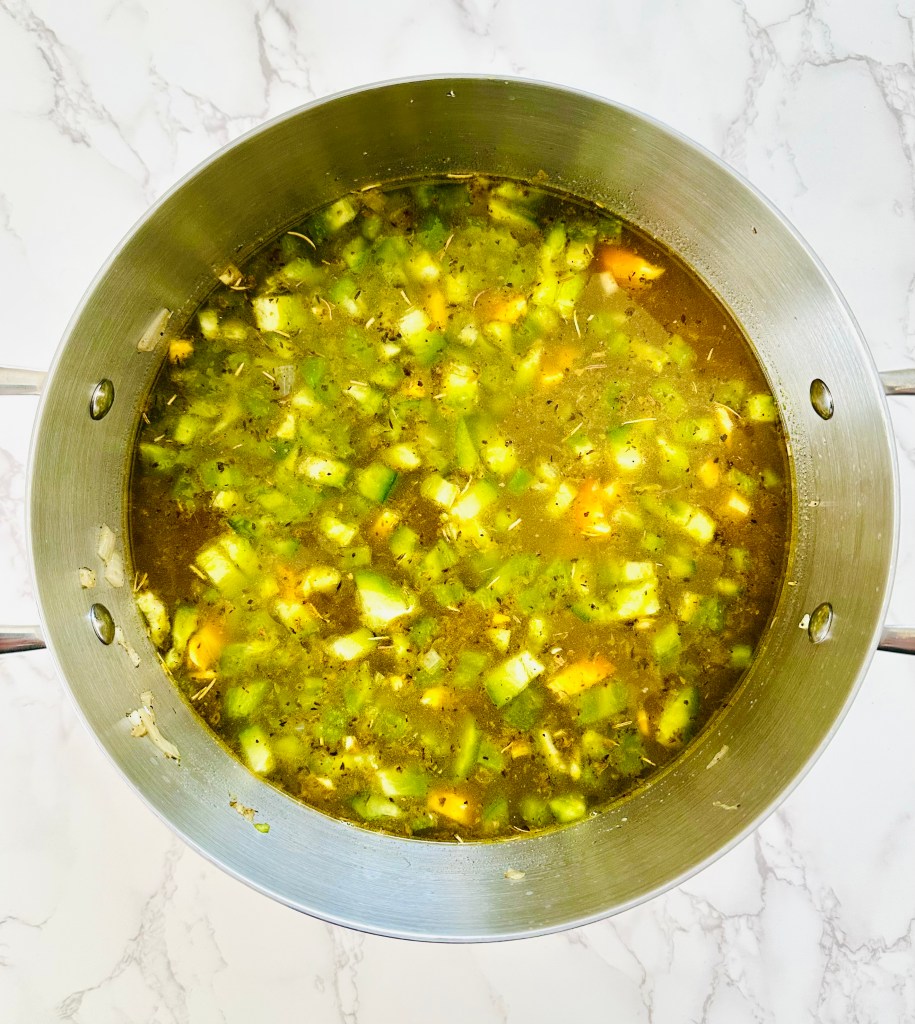 Soup pot full of sauteed veggies in vegetable broth