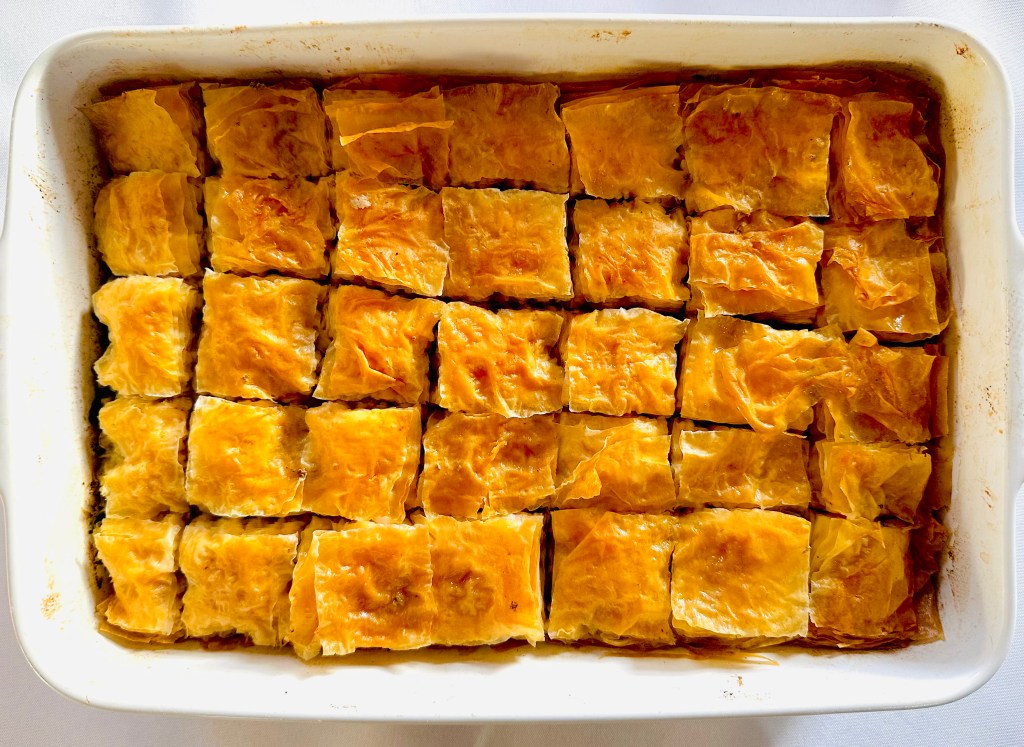 A baking dish full of savory baklava prepared with ground beef and onion filling