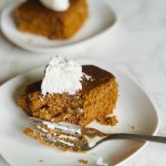 A slice of homemade molasses cake with whipped cream