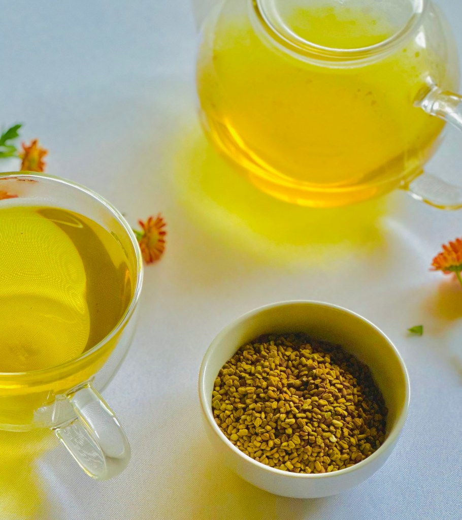 A freshly prepared teapot and cup of warm fenugreek tea
