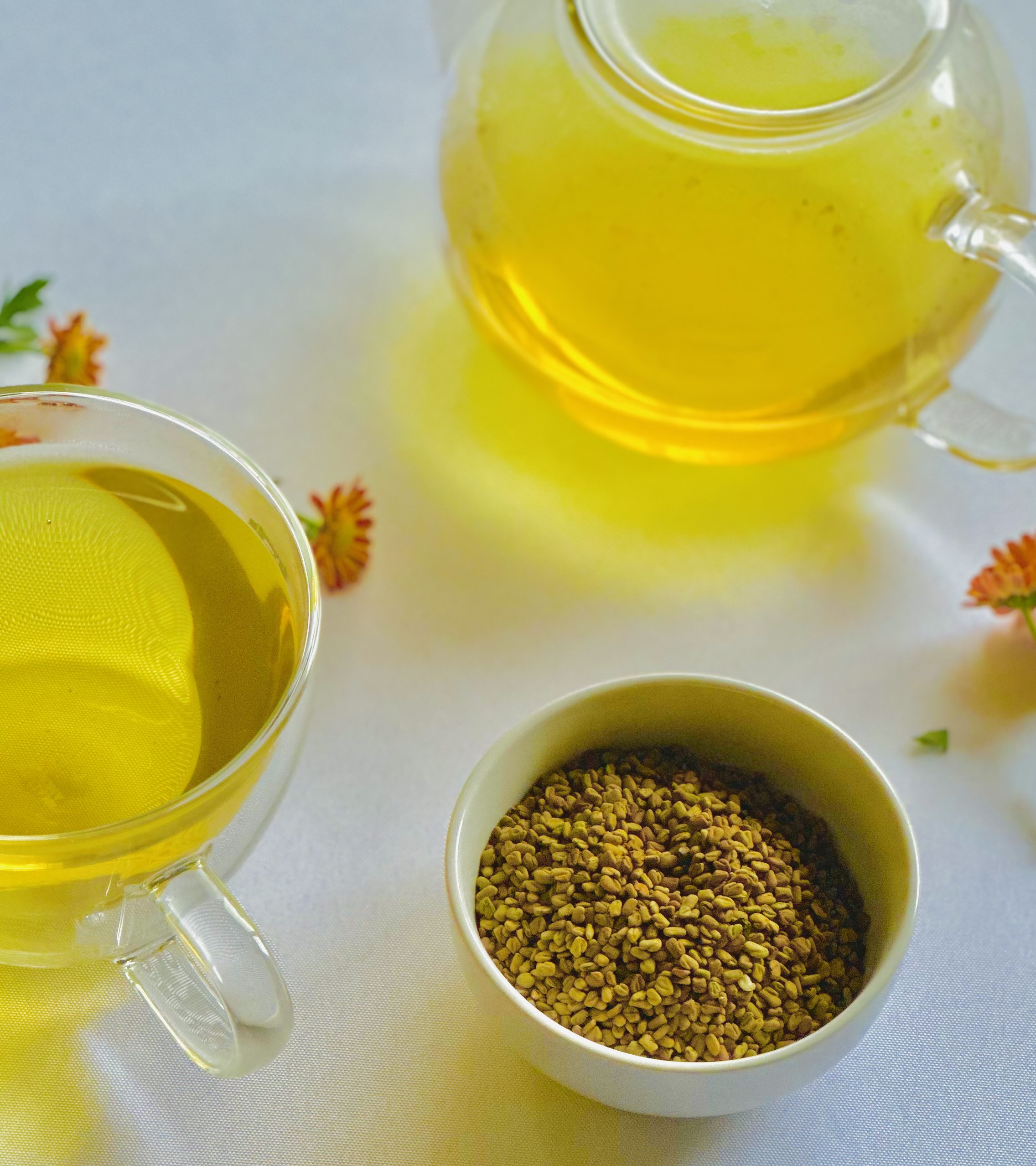 A freshly prepared teapot and cup of warm fenugreek tea