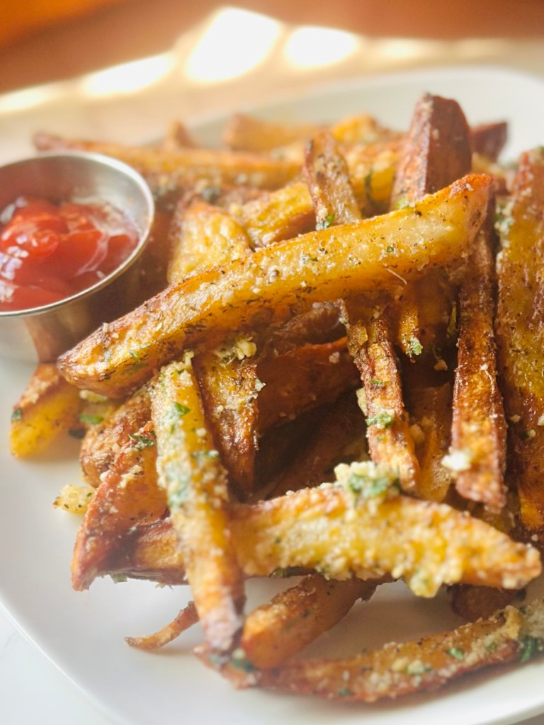 Air fry garlic Parmesan French fries served alongside homemade ketchup