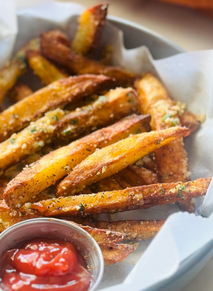 Air fry garlic Parmesan French fries served alongside homemade ketchup