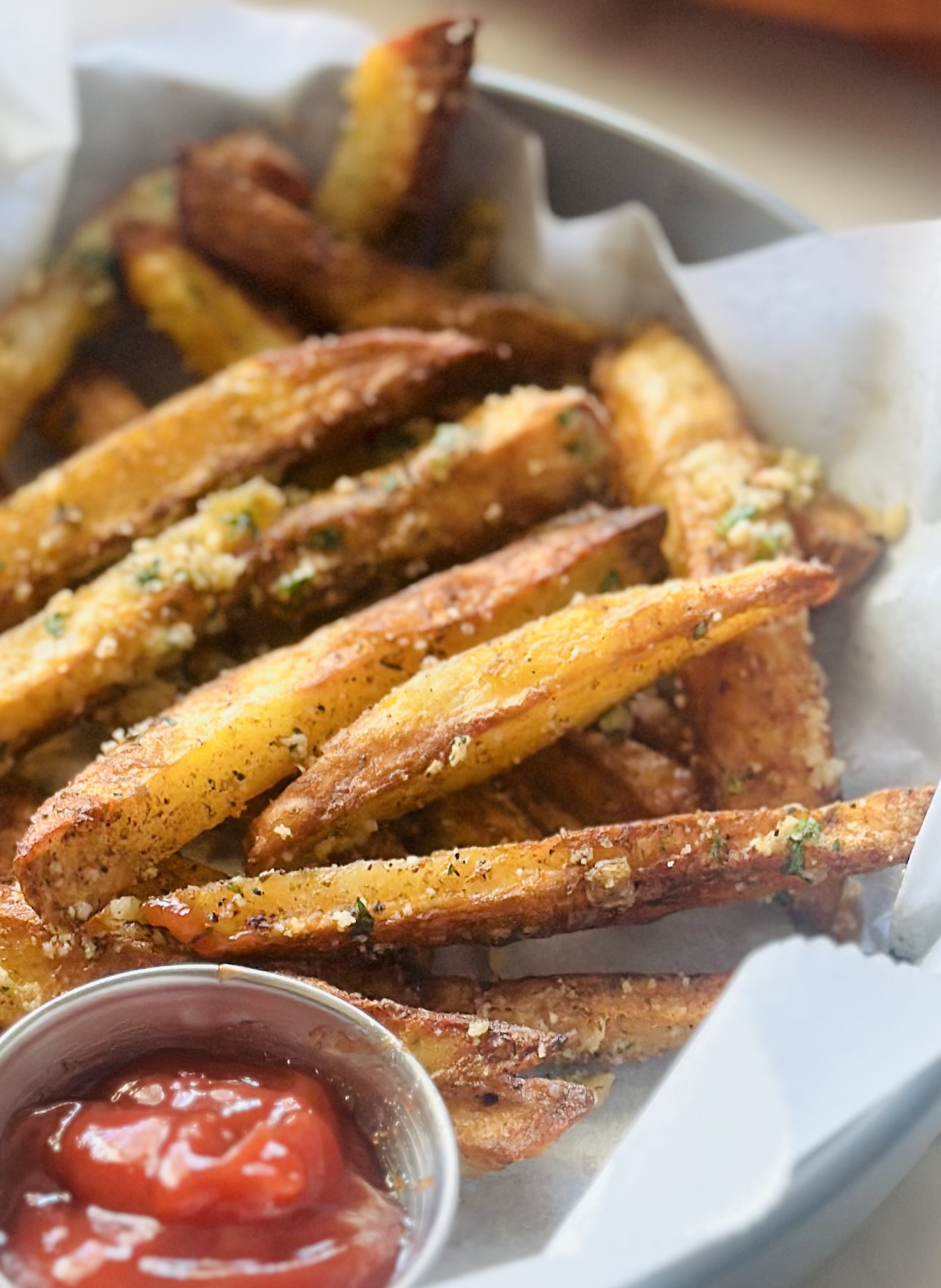 Air fry garlic Parmesan French fries served alongside homemade ketchup