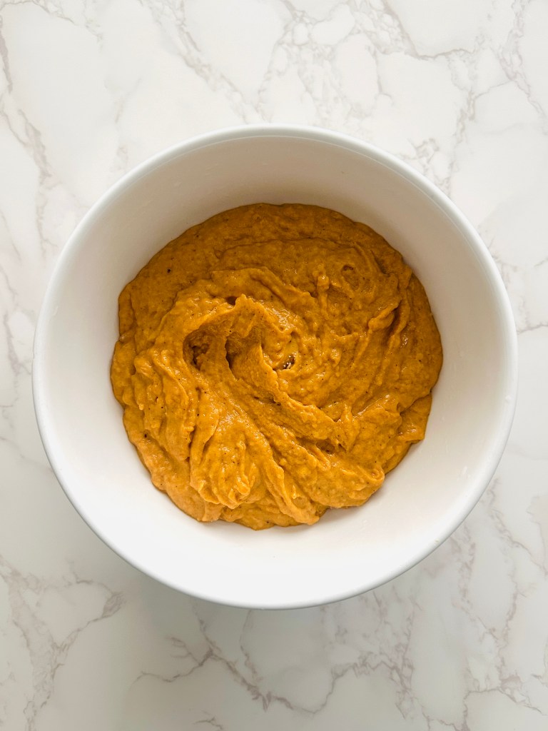 A large bowl of batter for pumpkin cupcakes